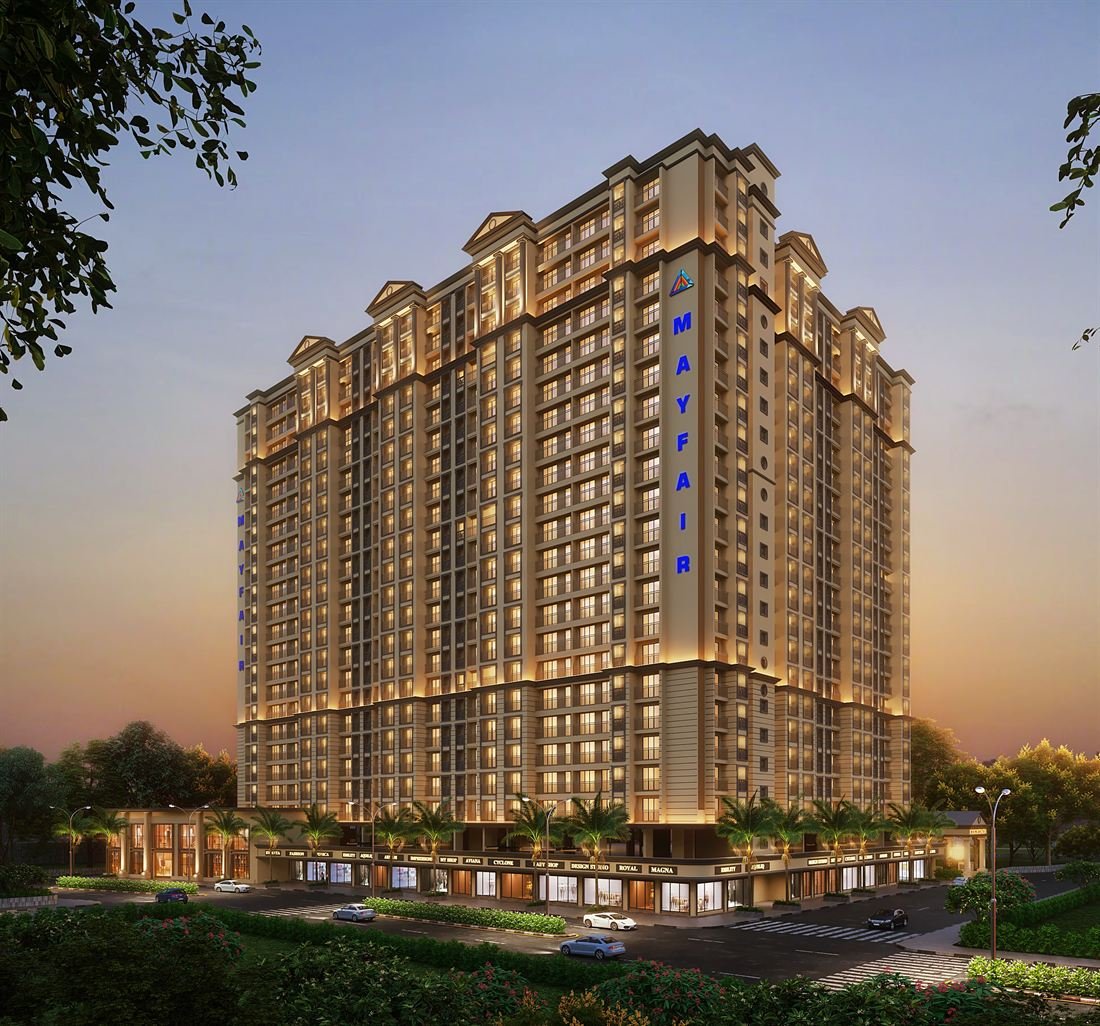 Mayfair Virar Gardens tower lit up in the evening with shops along the road, Virar West